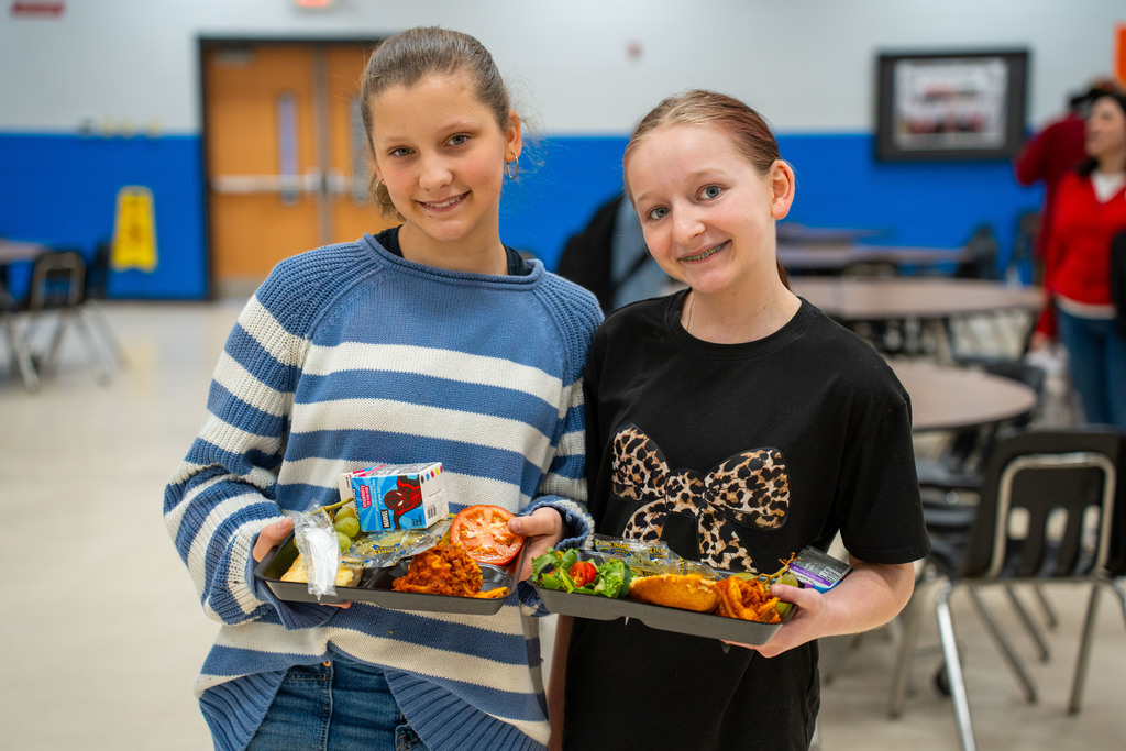 students with lunch trays of holiday meal option