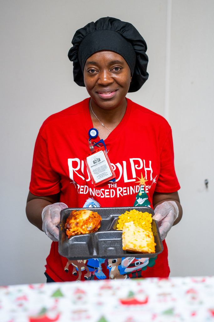 CNS worker with Holiday Meal tray