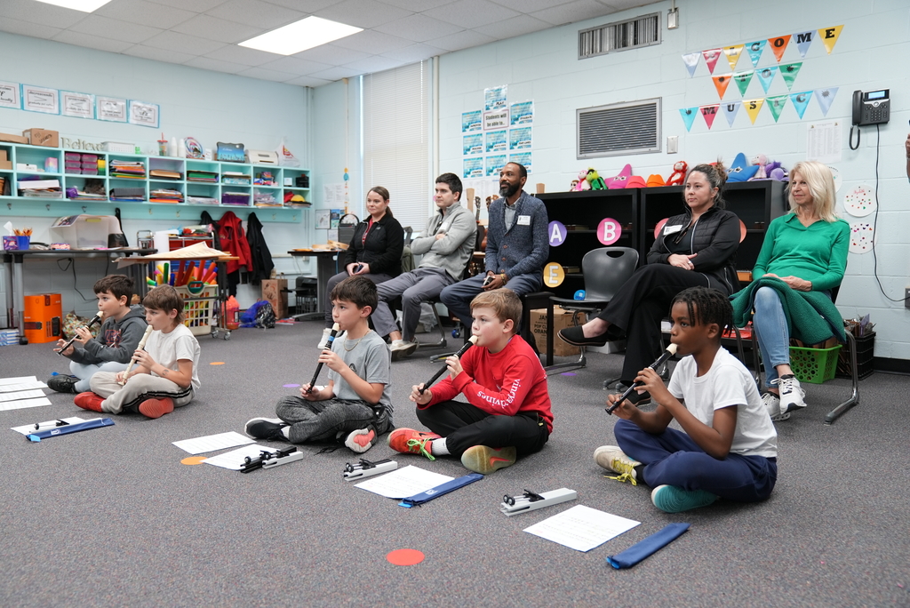 kids learning recorder and parents watching