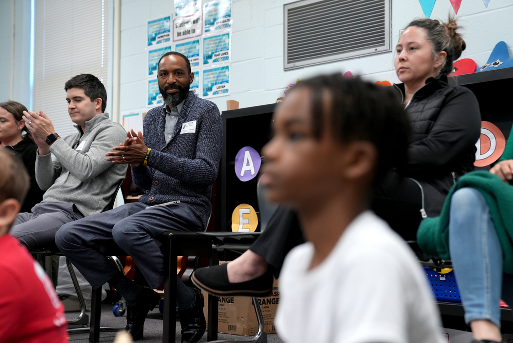 parent clapping looking at son
