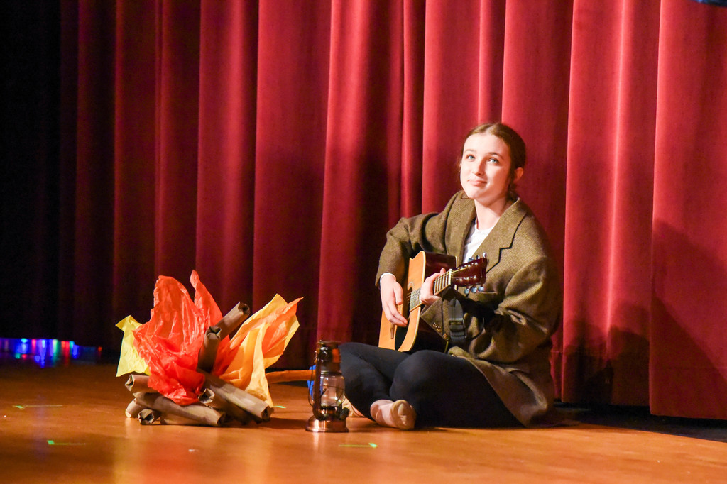 student playing the guitar