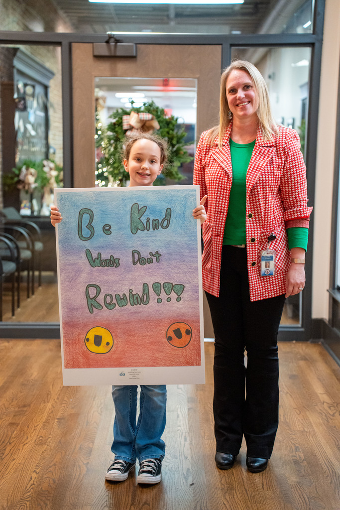 student smiling with poster