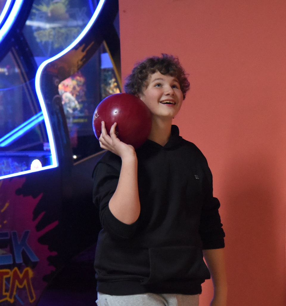 student smiling with bowling ball