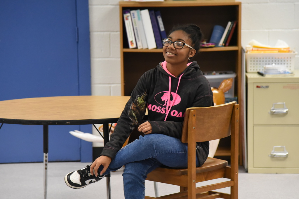 student smiling in chair