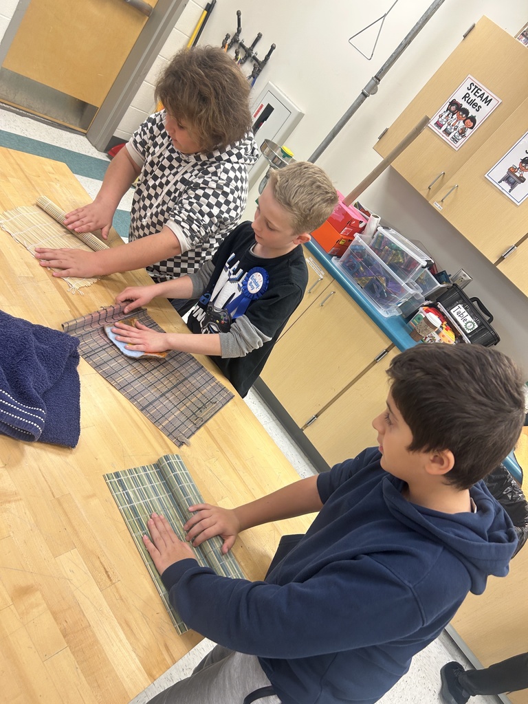 Students push the water out of their felted products.