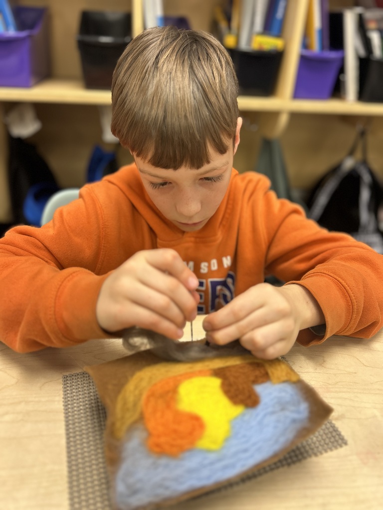 Students pushed wool onto their canvas.