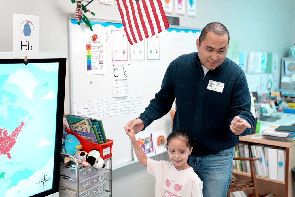 parent with student giving presentation