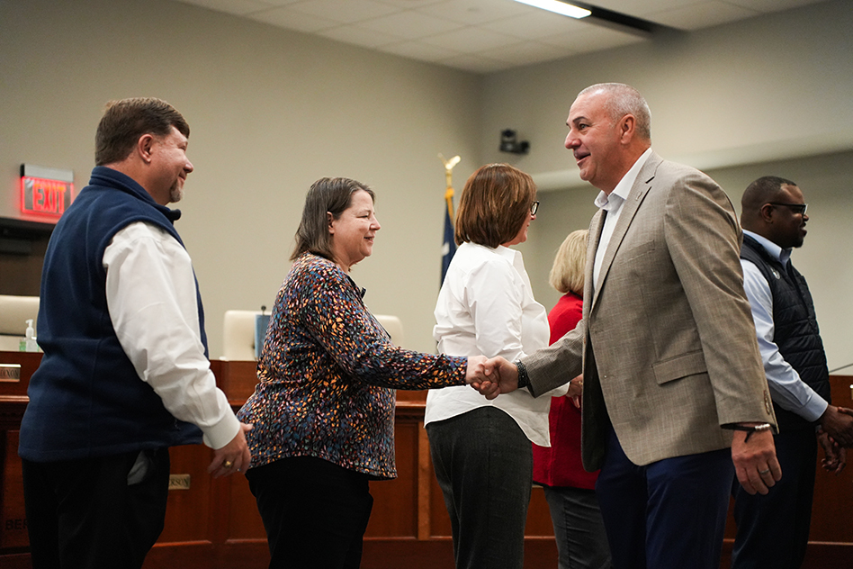 Coach Taylor shaking board members hands