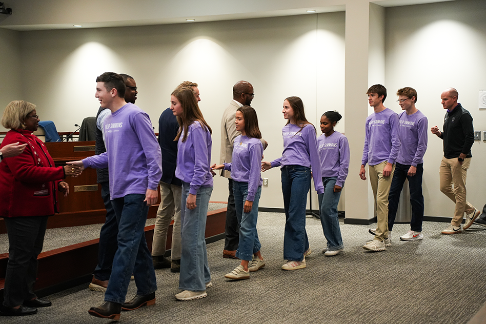 PSH Cross Country runners shaking board members hands