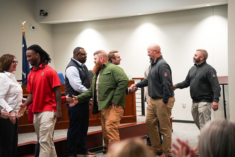 Meliq McGowan  and SHS admin shaking board members hands