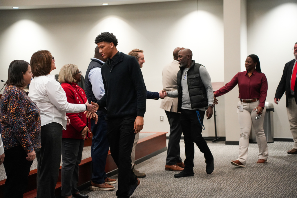 Caden Ramsey shaking board members hands