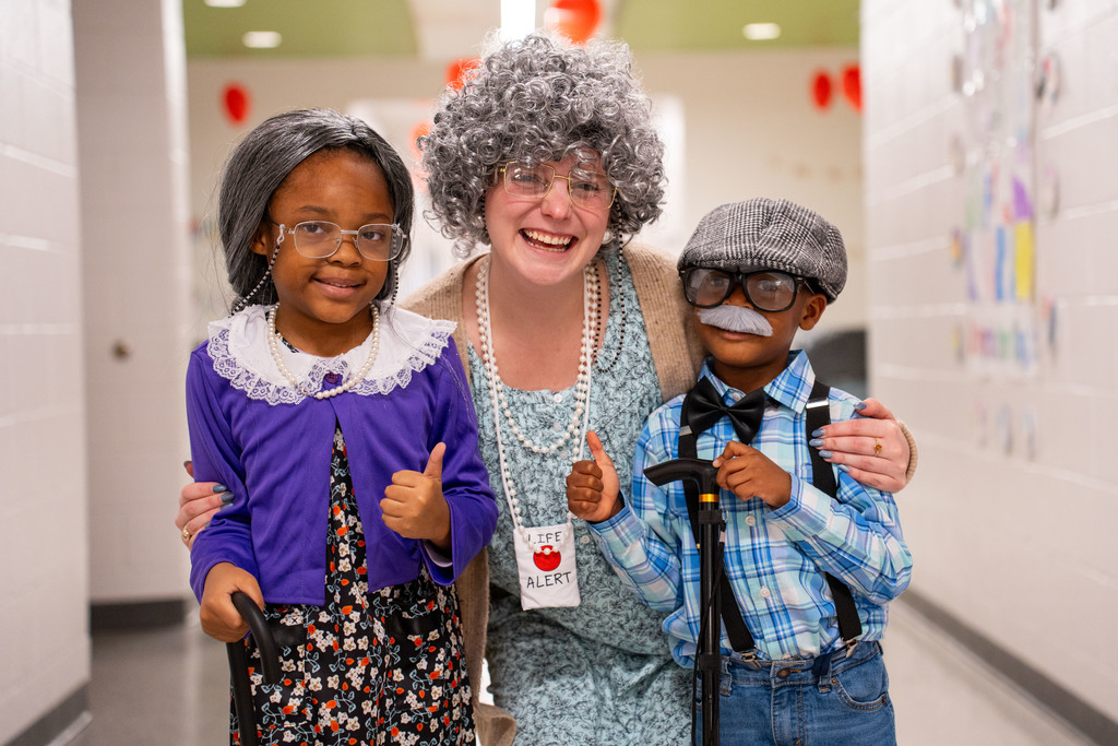 students and teacher dressed as the elderly