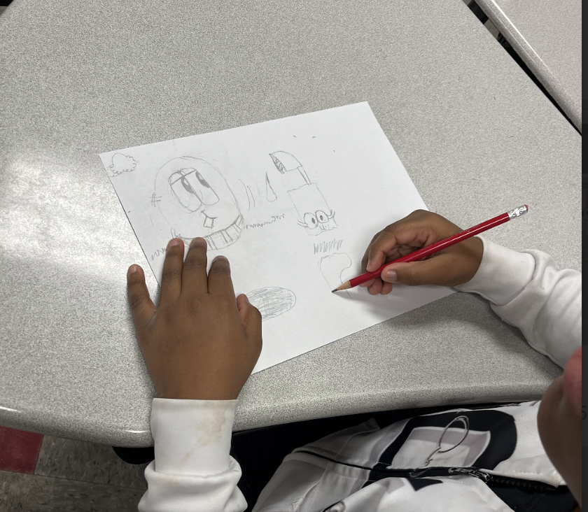 Picture of a students drawing, cartoon characters from an EGG, Juice Box and a Sock