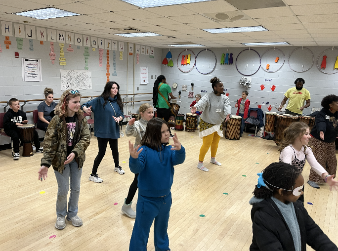 Multiple children and adults dancing in the dance room 