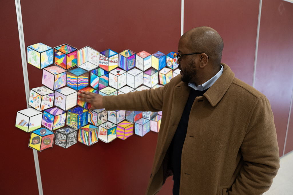 Dr. Dixon observing students' artwork