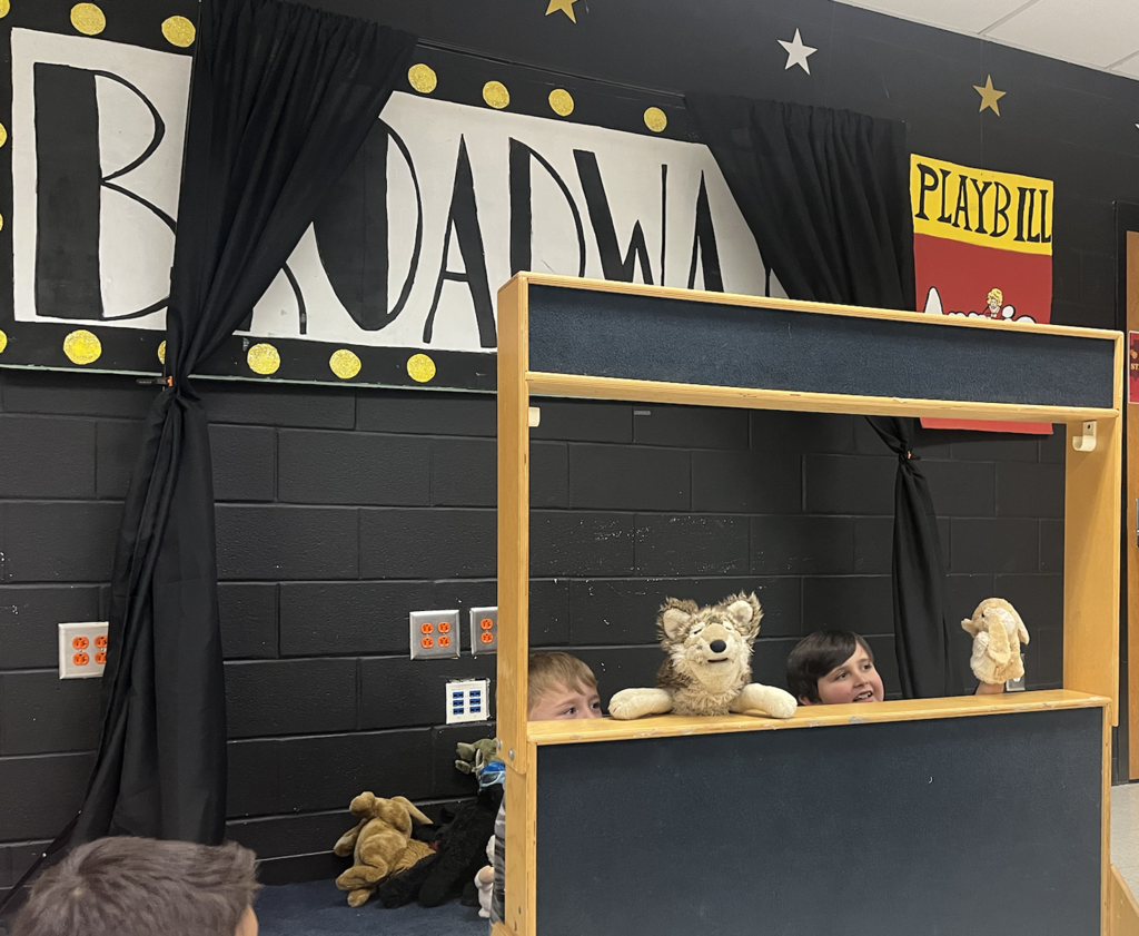 Two students putting on a show at the puppet theatre!