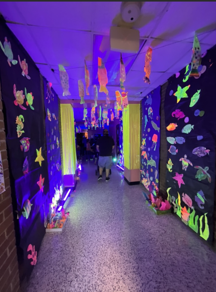 Photos of our glow hall from the art show in 2025! Feature walls with black paper and glow in the dark fish and sea creatures