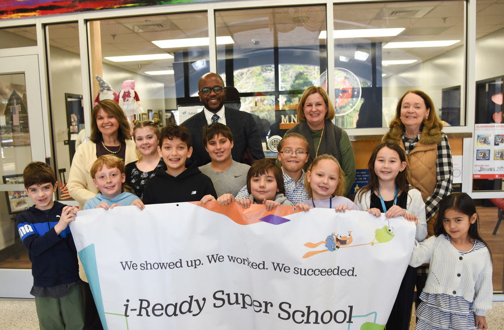 MNE students being presented the i-Ready Super School banner 