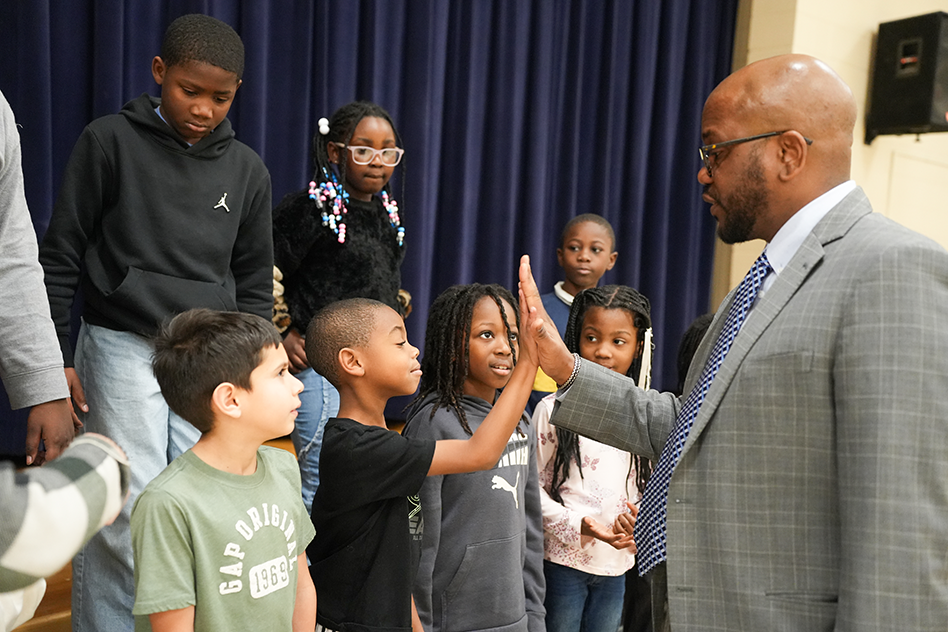 Dr. Dixon high fiving top students