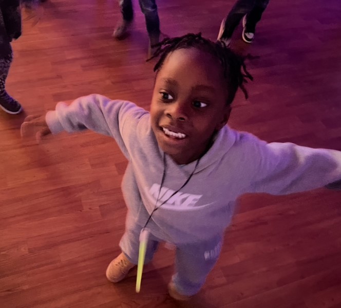 Youing boy with gray nike sweatsuit shows off his dance moves