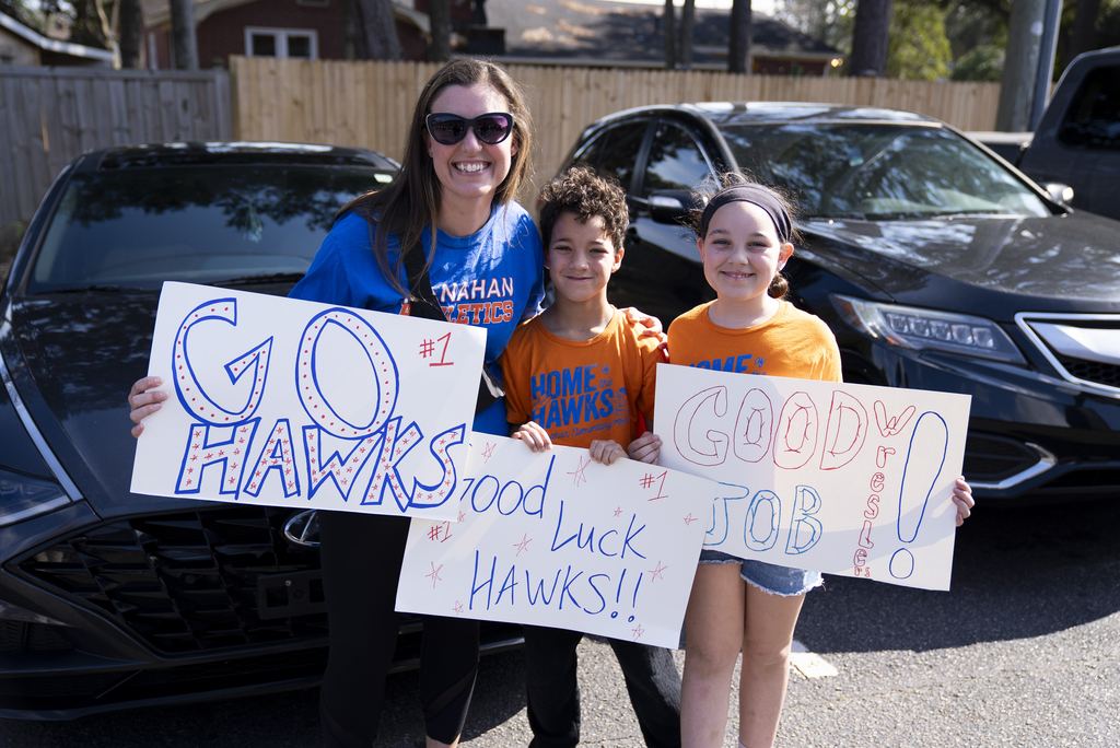 parents and siblings with handmade posters