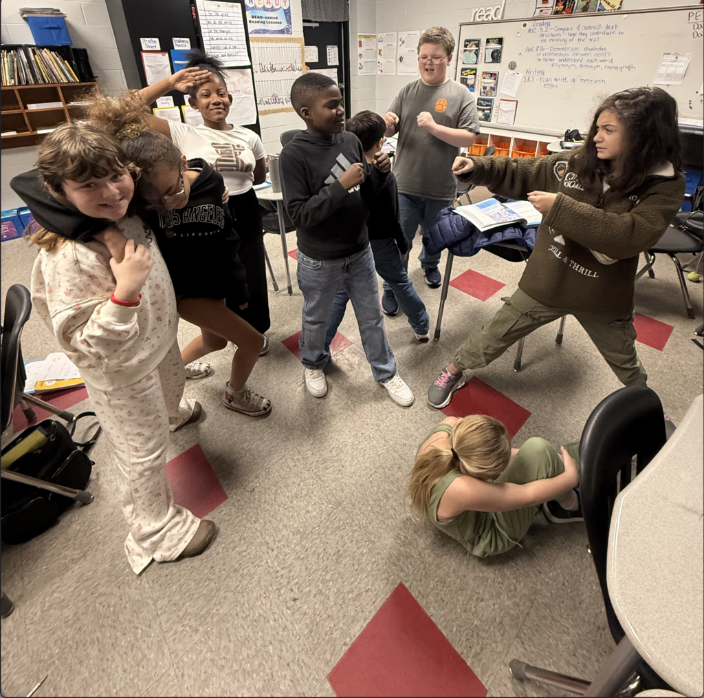 Students working together to create tableau to summarize their story