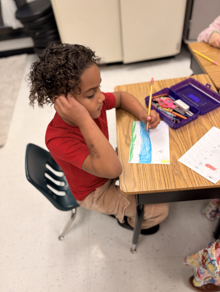 Student workng on their illustration at their desk