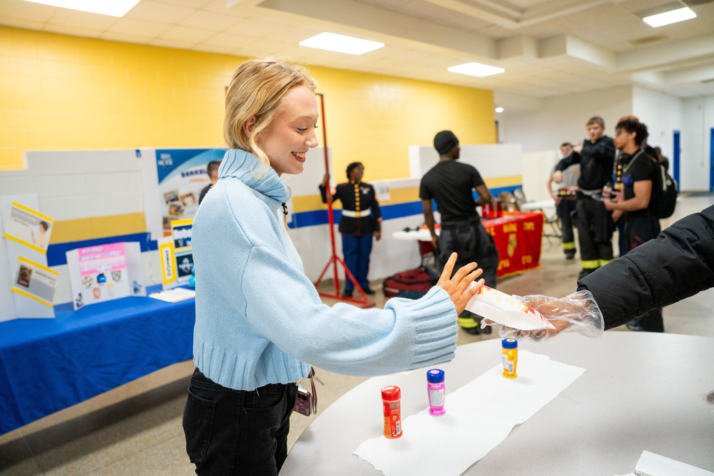 student being handed popcorn