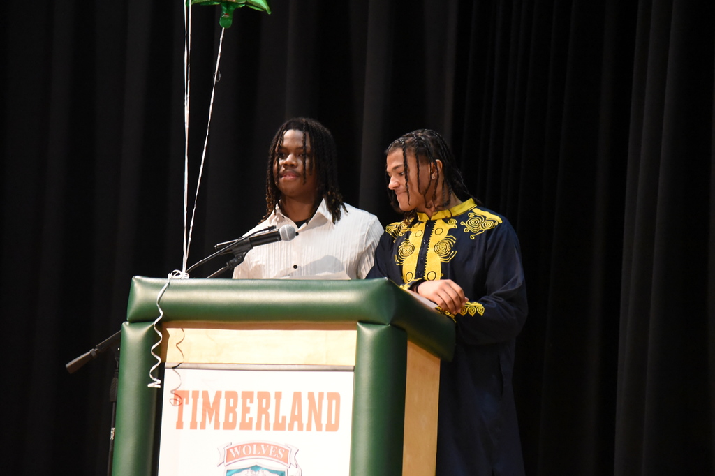 students presenting at podium