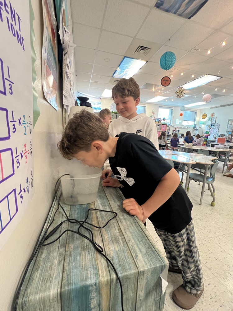 boy in black with steam experiment 