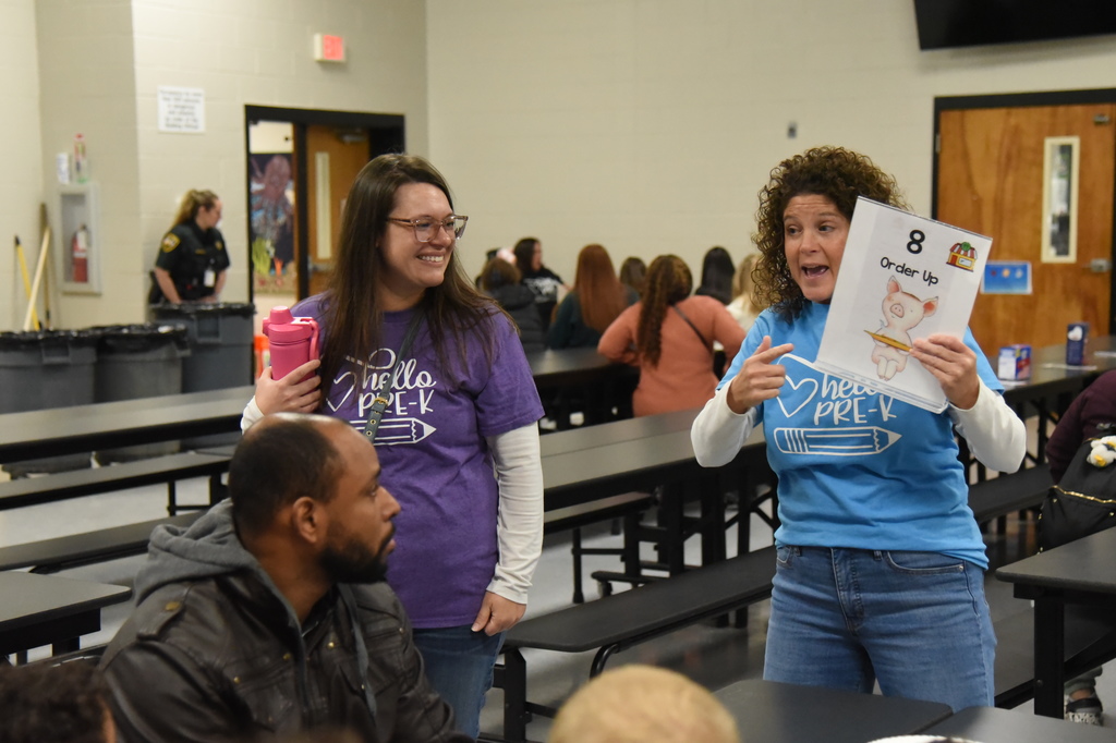 teacher pointing to sign