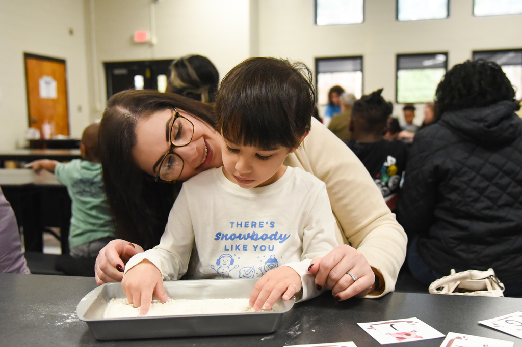 studetn wrting letters in flour
