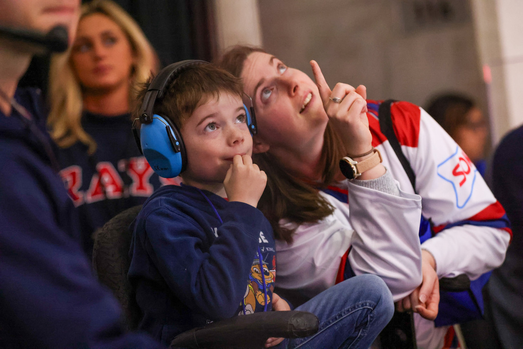 student with parent watching the game