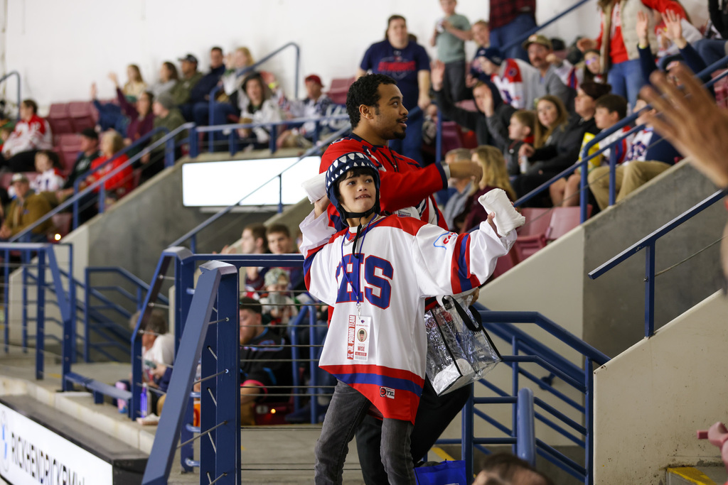 student throwing t-shirt to the crowd