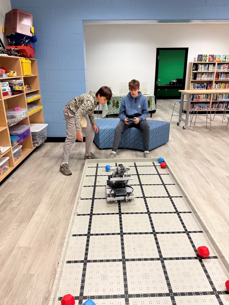 Students explore different hands on robots in the school library. 