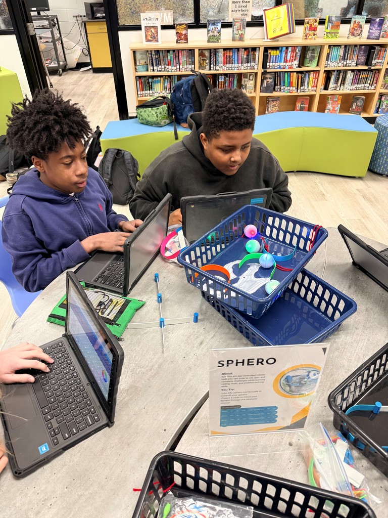 Students explore different hands on robots in the school library. 