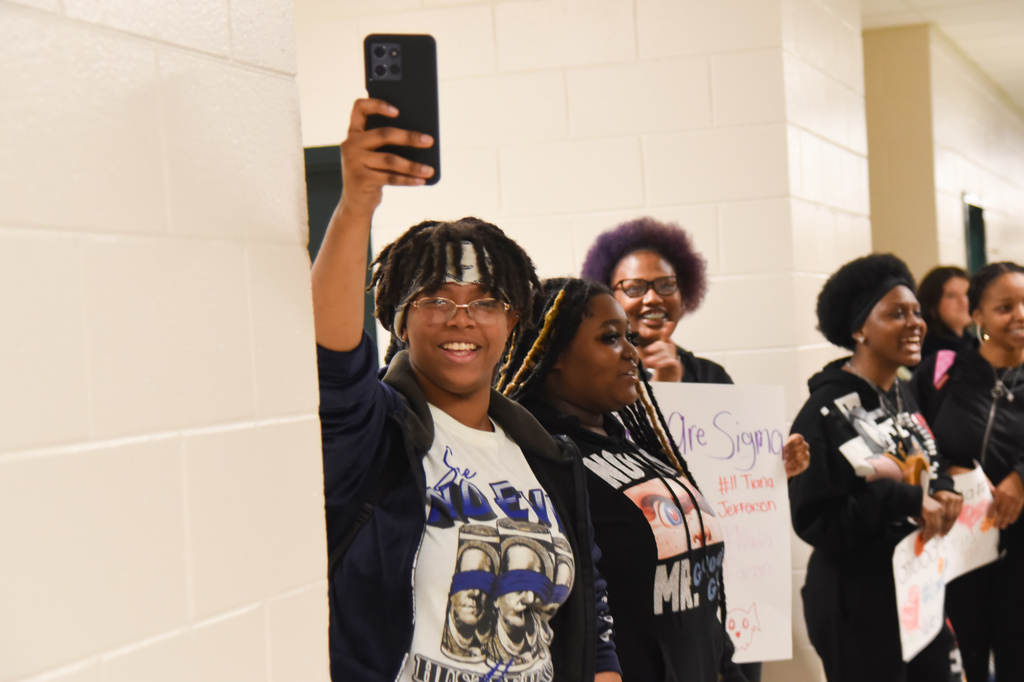 student filming parade