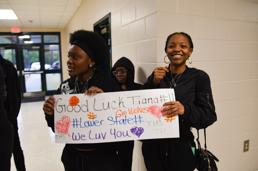 students holding sign