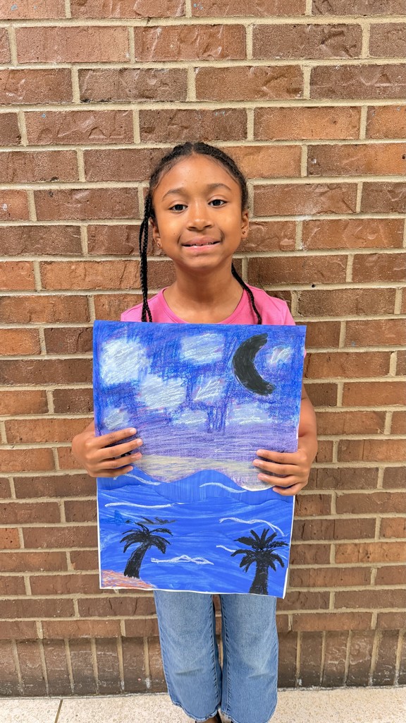 Student standing in front of brick wall holding oil pastel horizon photo