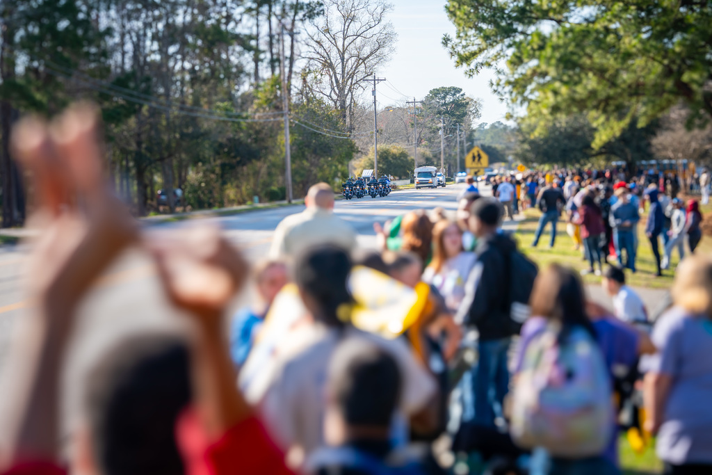 bus driving past crowd