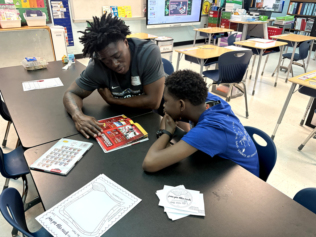 CSU football player helping student read
