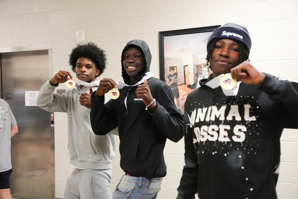 students showing off medals