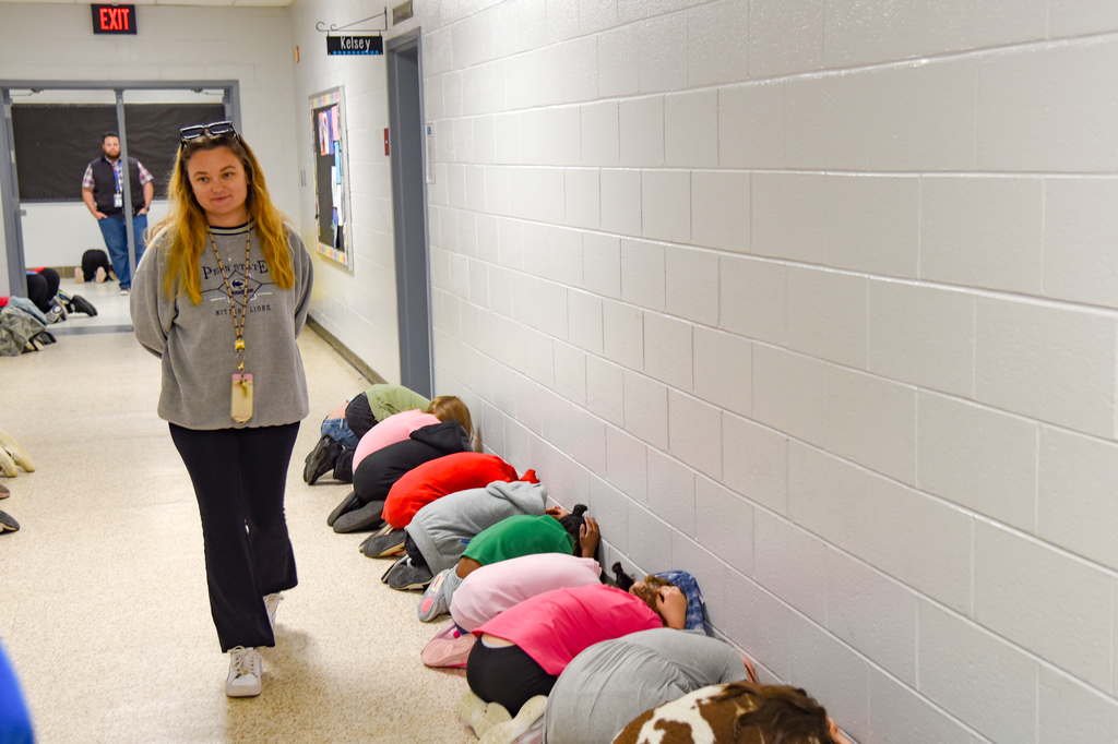 teacher observing student while practicing tornado drill