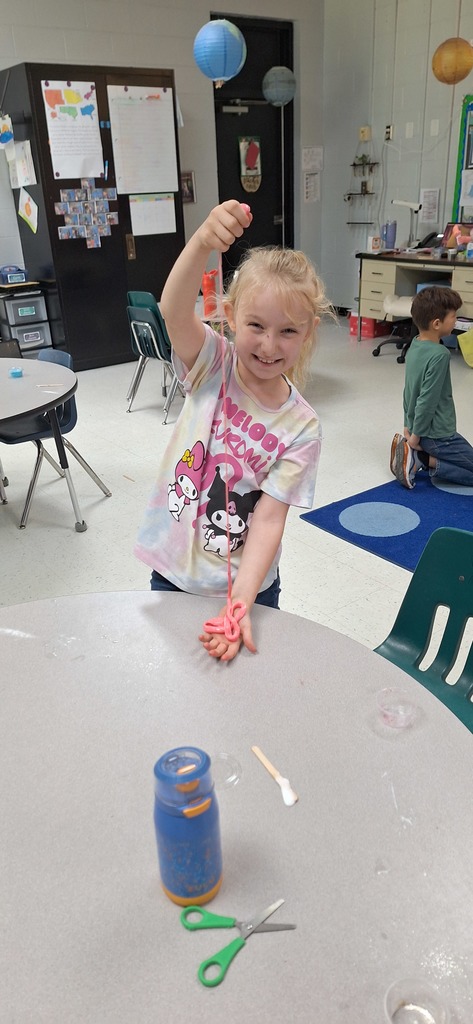 One student stretching their orange slime