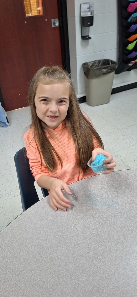 One student smiling with her blue slime