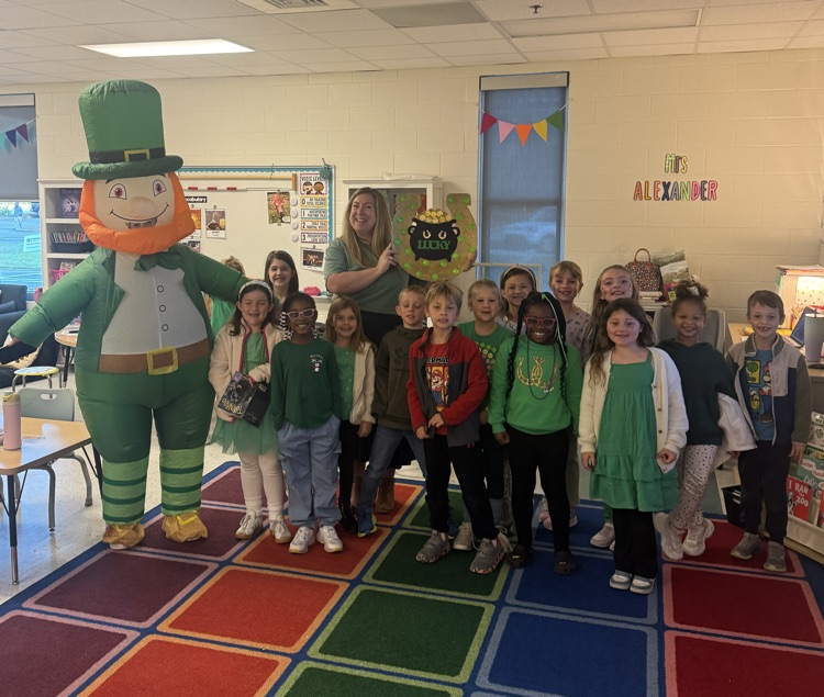 leprechaun and class pose for photo