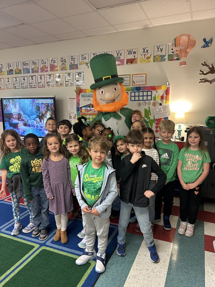 leprechaun and class pose for photo