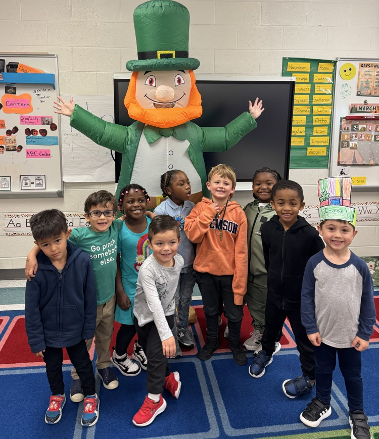 leprechaun and class pose for photo