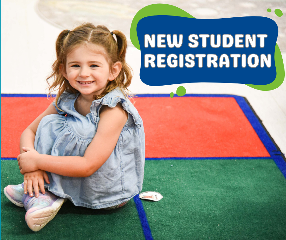 student sitting on carpet smiling at the camera with the words "New Student Registration" in a blue and green box in the top right corner of the picture