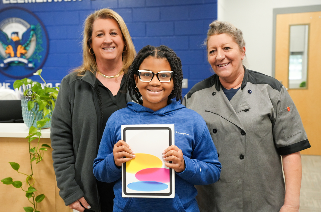 student receiving an iPad from BCSD Child Nutrition 